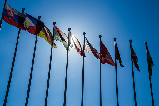 Waving flags in blue sky