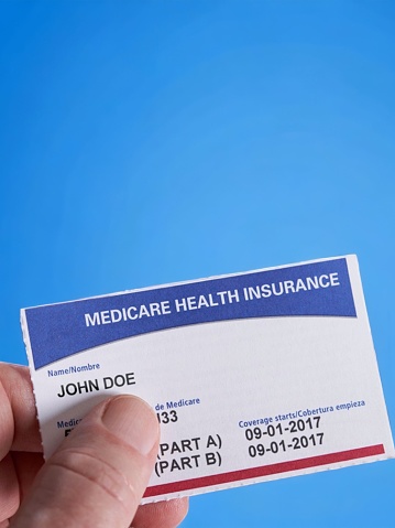 Hand holding Medicare card