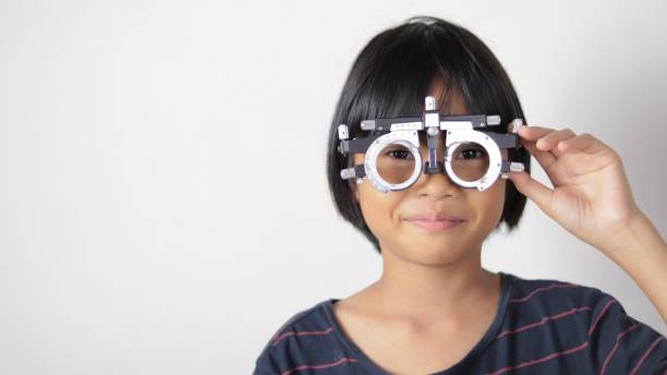 istock Elementary school girl wearing eyeglasses visual acuity test with test chart, eye test, Female patient checking eyesight in ophthalmology clinic, eye check 1491149682