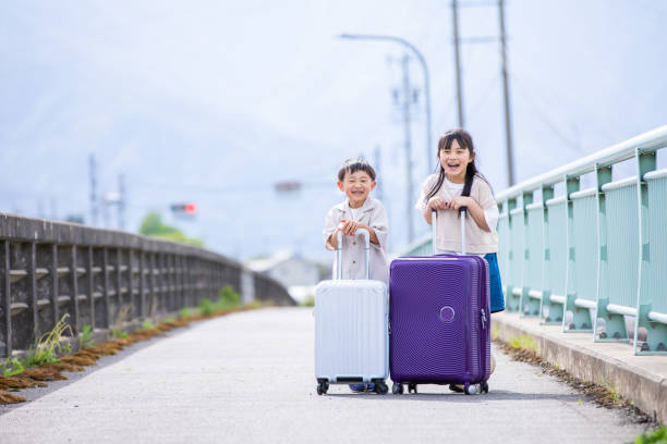 A child who smiles with a suitcase