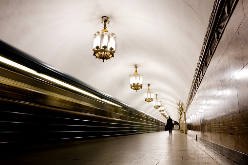 Photograph of a man on a metro platform as the train pulls away