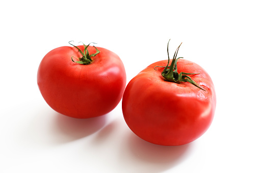 Two ripe tomato with shallow depth of field, isolated on white with clipping path.