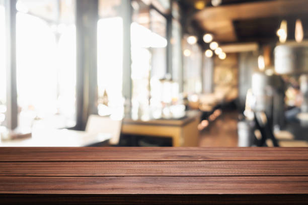 istock Empty wooden table space platform and blurred resturant or coffee shop background for product display montage 1491159497