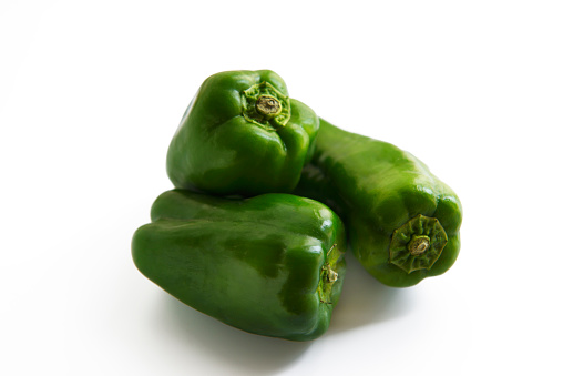 High angle view of three green bell pepper, isolated on white with clipping path.