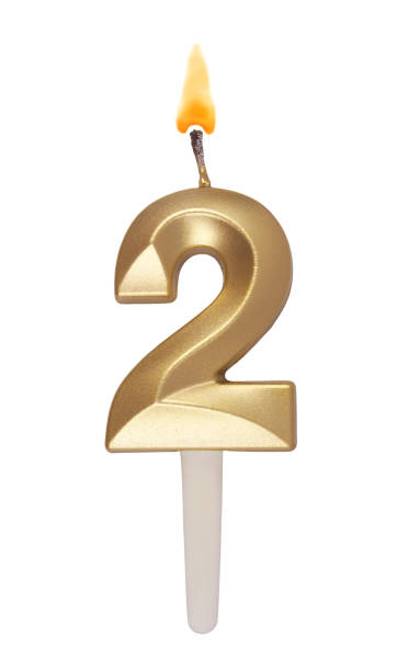 istock Gold birthday candle isolated on white. Number 2. 1491160830