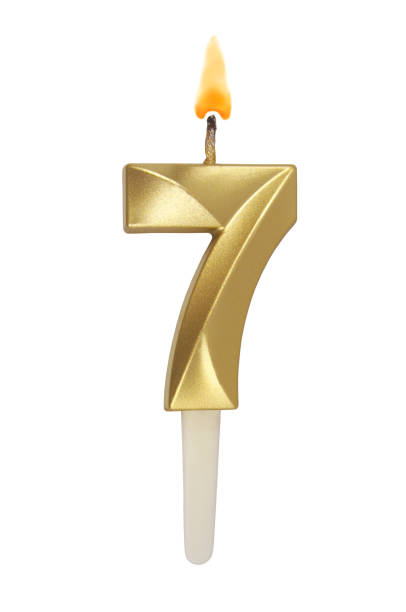 istock Gold birthday candle isolated on white. Number 7. 1491160853