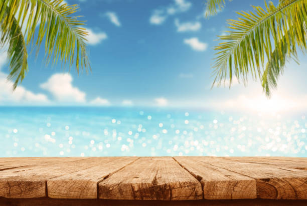 istock Empty wooden table are placed outdoors on spring sunny sky background with blue sparkling sea water and bokeh blurry. Counter display concept 1491163169