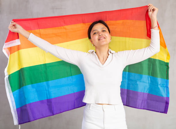 istock Young woman posing in studio with LGBT flag 1491164402