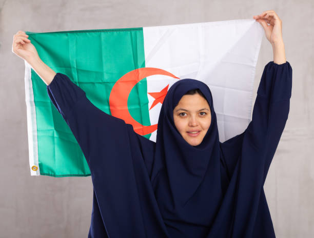 istock Young woman in hijab posing with Algeria flag 1491164448