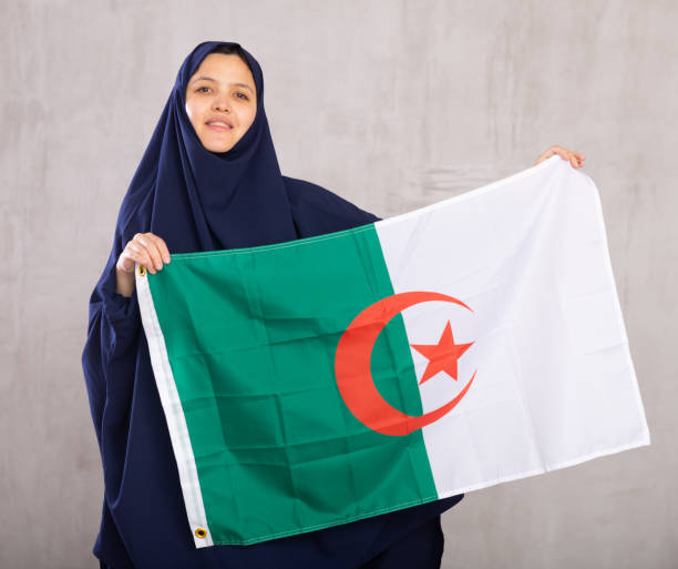 istock Young woman in hijab posing with Algeria flag 1491164450