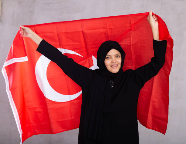 istock Young woman in hijab posing with Turkey flag 1491164618