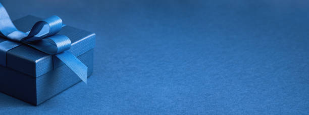 istock Part of gift box with a blue bow on blue 1491164655