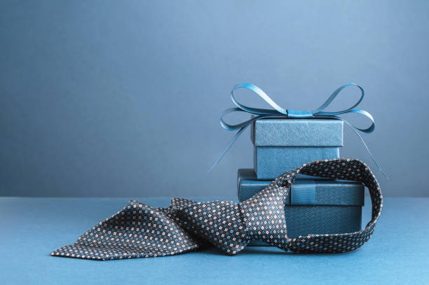 istock Happy Fathers Day background. gift box and necktie on blue table. 1491164659