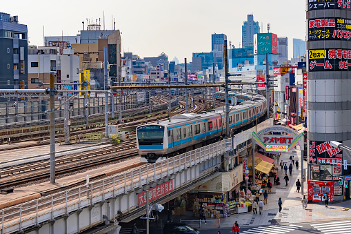 Japan - April 5, 2023 : JR Kehin-Tohoku Line Train ran on the railway pass Ameyoko Market, Ueno, Tokyo