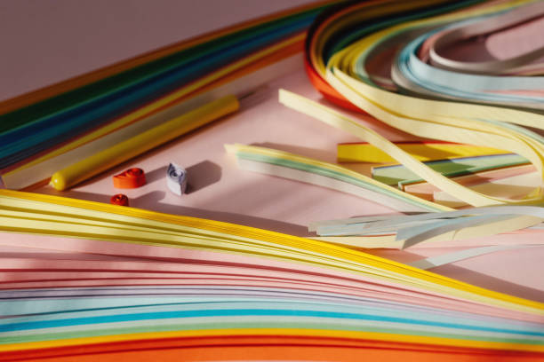 istock Paper and quilling tools on a pink background with space for text and design. 1491173830
