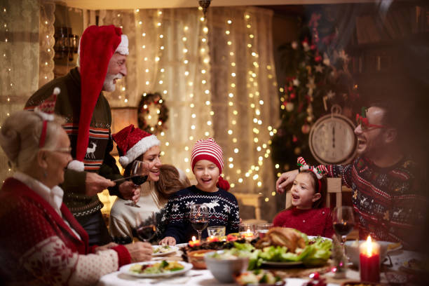 istock Happy multi-generation family enjoying in Christmas dinner at dining table. 1491174625
