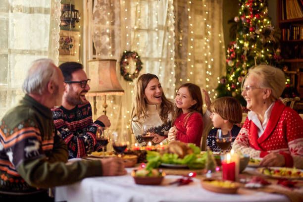 istock Cheerful extended family talking during Christmas dinner at home. 1491174893