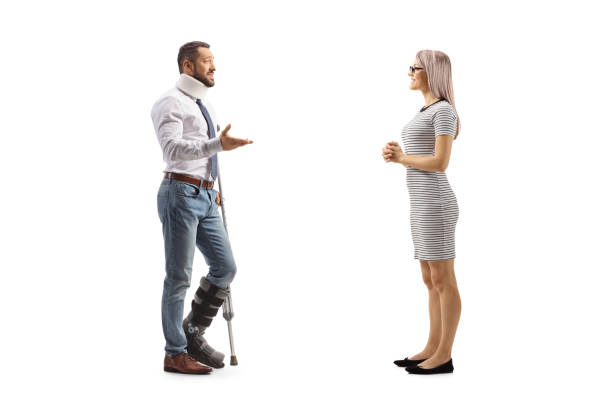 injured man with an orthopedic boot and cervical collar talking to a woman - physical injury men orthopedic equipment isolated on white imagens e fotografias de stock