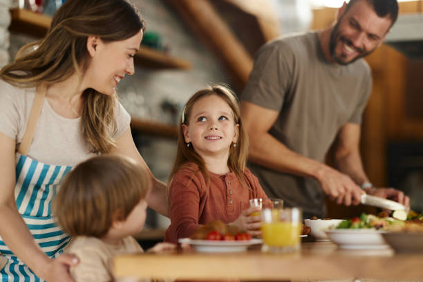 istock Happy family talking during breakfast at dining room. 1491176062