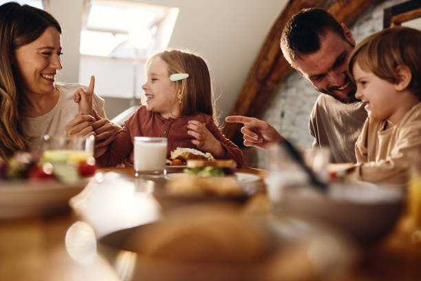 istock Young family talking during breakfast at dining table. 1491176394