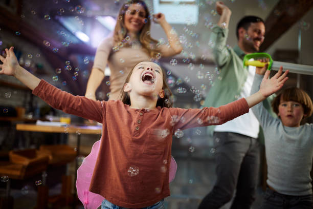 istock Cheerful girl having fun while dancing with her family at home. 1491177082