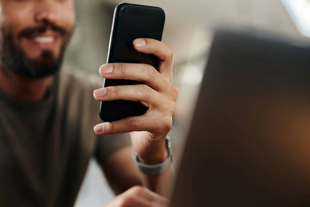 istock Close up of a man using cell phone at home. 1491177724