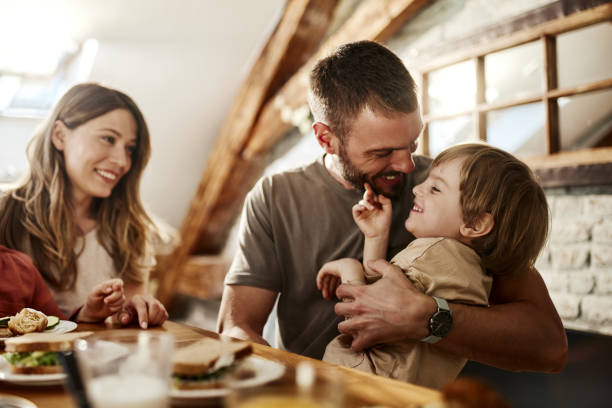 istock Happy father and son having fun during family's breakfast at dining table. 1491178119