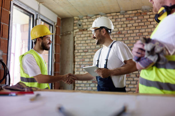 istock Happy manual workers came to an agreement at construction site. 1491178450