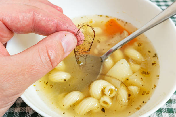 Man found long hair in his plate of soup and isn't satisfied with the food. Situation causing nausea. Failure to follow hygienic cooking practices, bad customer service, no chef s hat. ugly soup stock pictures, royalty-free photos & images