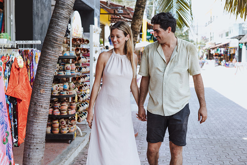 hispanic young couple of tourists shopping on vacations or holidays in Mexico Latin America, Caribbean and tropical destination