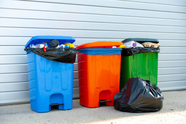 istock Three trash containers full of garbage near the building 1491184825