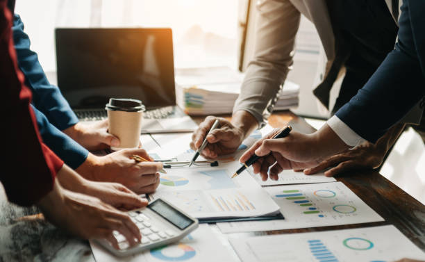 istock Businessman and team analyzing financial statement Finance task. with smart phone and laptop and  tablet. Wealth management concept 1491184954