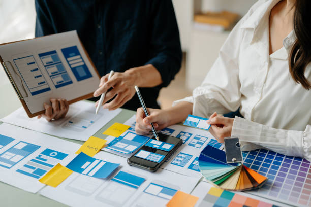 istock View of UI developer team brainstorming on their project with laptop, smartphone and digital tablet. Creative digital development agency. 1491185516