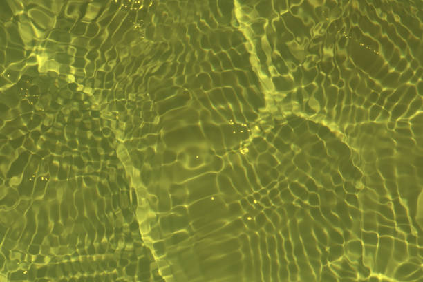 istock Blue water with ripples on the surface. Defocus blurred transparent blue colored clear calm water surface texture with splashes and bubbles. Water waves with shining pattern texture background. 1491186081