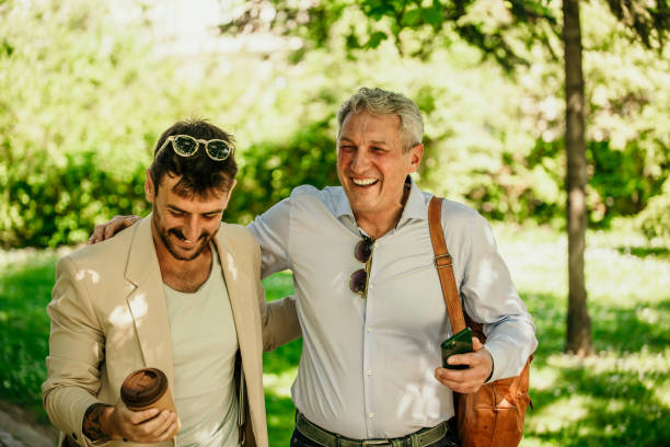 istock Two friendly businessmen meet and walk outdoors. 1491186355