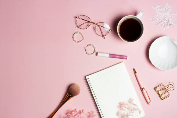 istock Women items concept with notebook, coffee cup, envelope and make up over the pink background. 1491189348