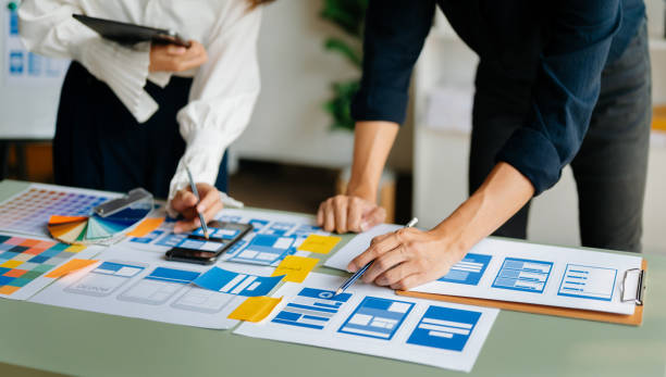 istock View of UI developer team brainstorming on their project with laptop, smartphone and digital tablet. Creative digital development agency. 1491191368