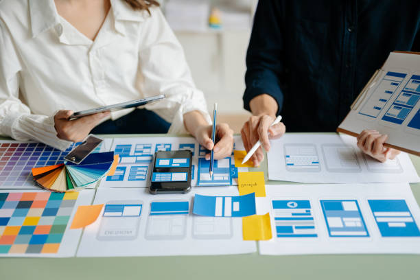 istock View of UI developer team brainstorming on their project with laptop, smartphone and digital tablet. Creative digital development agency. 1491191372