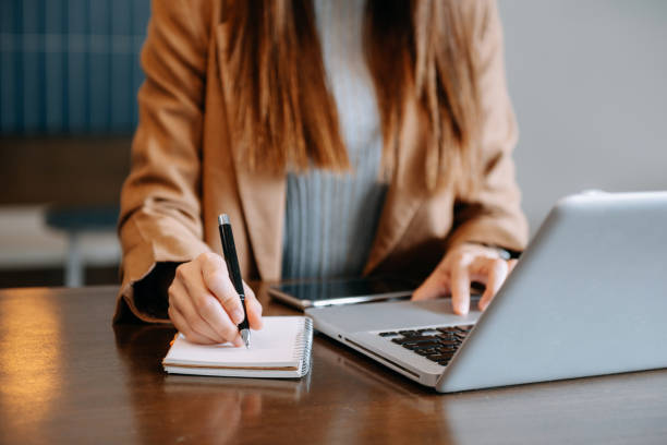 istock businesswoman hand working with new modern computer and writing on the notepad strategy diagram as concept 1491191494