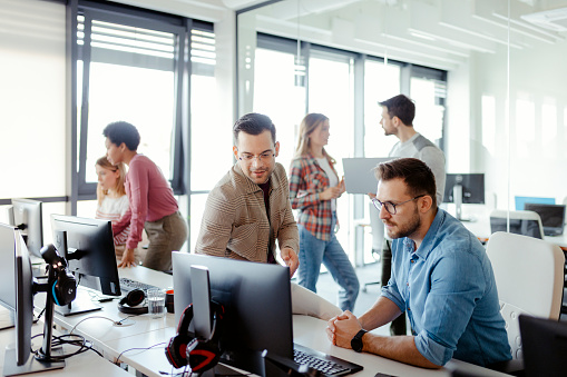 Two male programmers discuss project development. Startup business people group working everyday job at modern office