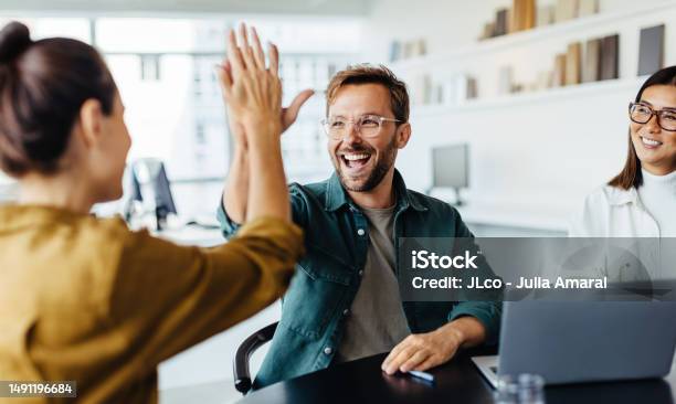 Business People Celebrating Success In An Office Stock Photo - Download Image Now - Teamwork, Happiness, Office