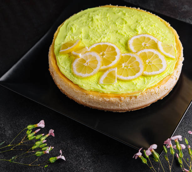 Layered Lemon Cheesecake on black plate