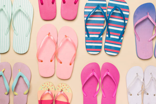 istock Many colorful flip flops on color background, top view 1491202029