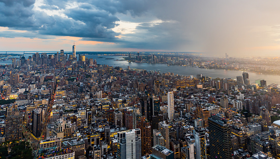 A rain storm over the Manhattan in New York City during beautiful sunset