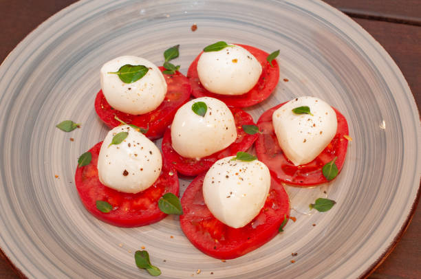 Tomato and mozzarella Caprese salad with sauce . High quality photo