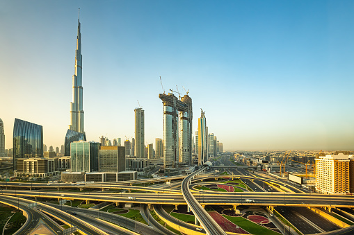 Modern skyscrapers with Burj Khalifa on side and roads along E11 Sheikh Zayed Road highway, Dubai, United Arab Emirates in early morning.