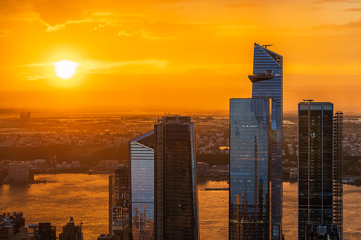 An orange sunset over the Hudson Yards in New York City.