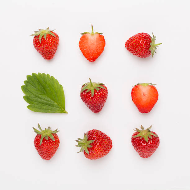 istock Strawberries with leaves on white background, top view 1491206981
