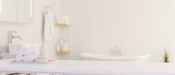 istock Copy space on a white tabletop with bath toiletries set in luxury white bathroom with bathtub. 1491208908