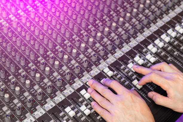 male sound engineer hands on audio mixing console. live, recording or broadcasting concept